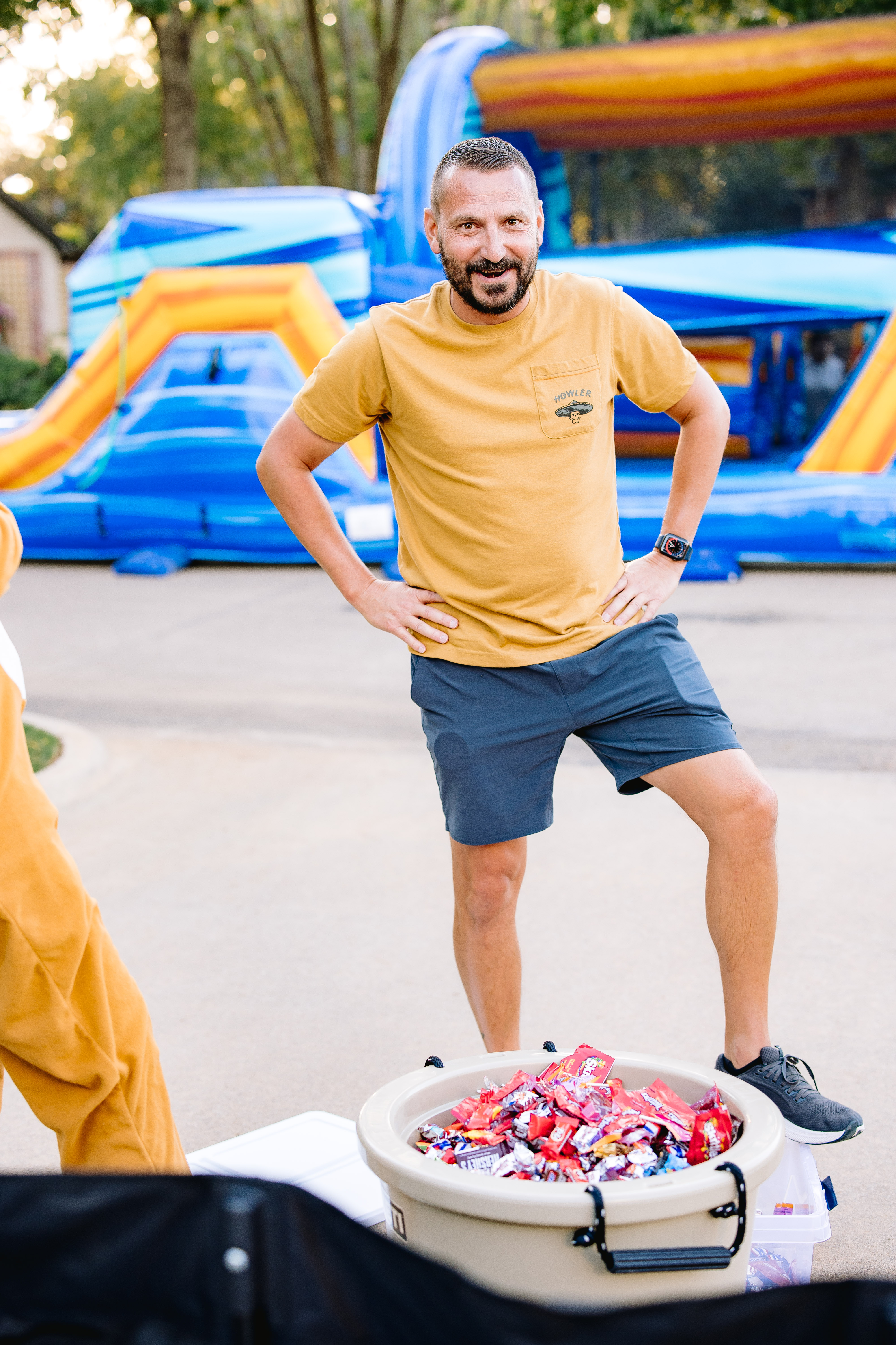 Homeowner with bounce house and candy at Halloween Walk